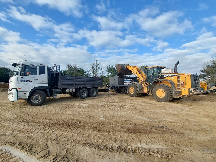 Soil being loaded into a Waipa Topsoil truck